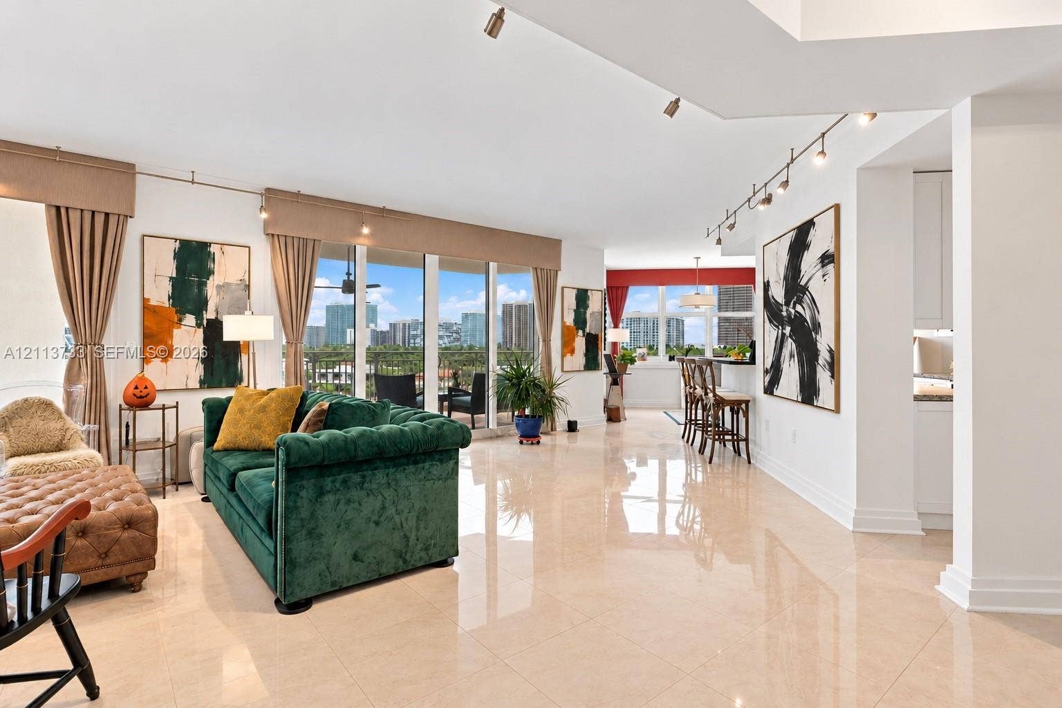 9751 E Bay Harbor Drive, #6A, Bay Harbor Islands, FL 33154 Open-concept interior featuring large-format tile flooring, floor-to-ceiling windows, and multi-directional track lighting