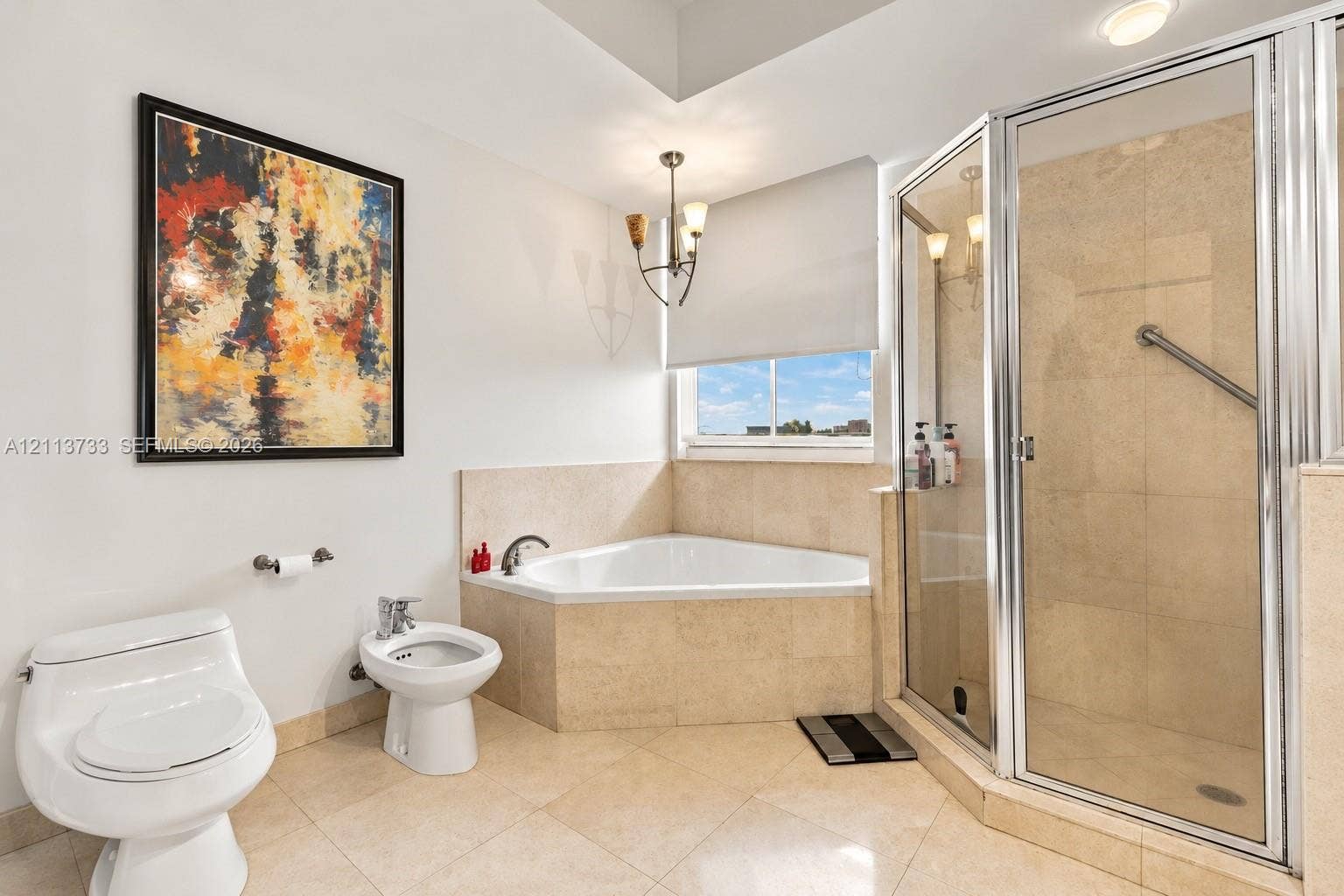 9751 E Bay Harbor Drive, #6A, Bay Harbor Islands, FL 33154 Corner soaking tub with stone tile surround, glass-enclosed shower, bidet, and tile flooring