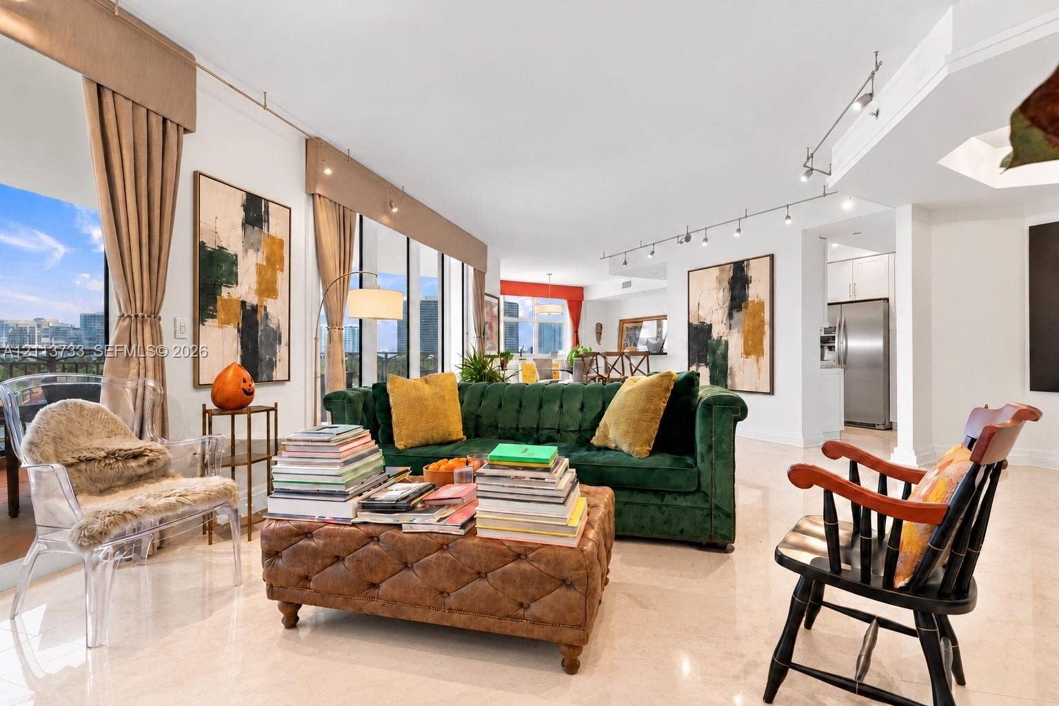 9751 E Bay Harbor Drive, #6A, Bay Harbor Islands, FL 33154 Floor-to-ceiling windows with integrated window valances, polished stone flooring, and adjustable track lighting