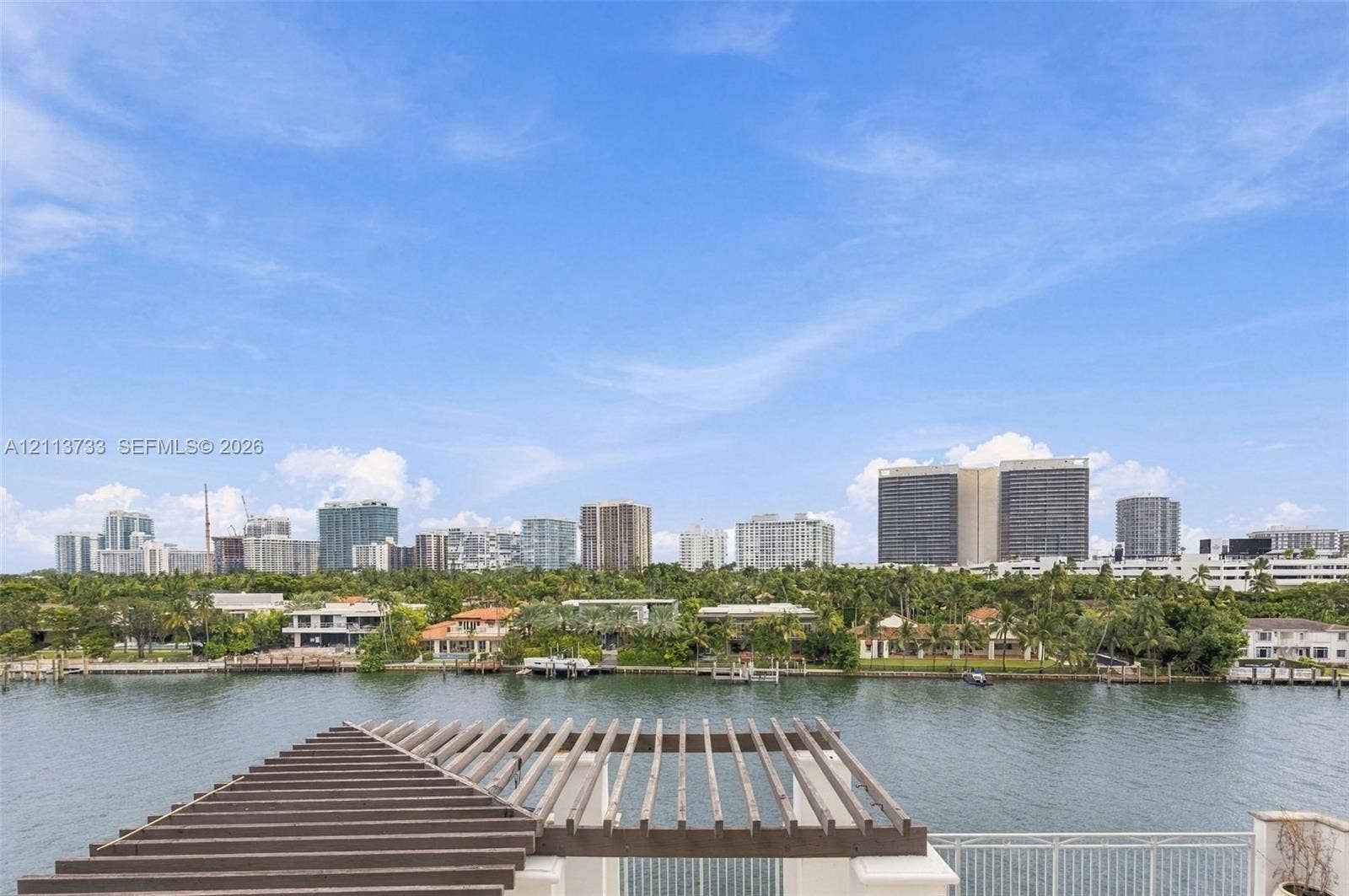 9751 E Bay Harbor Drive, #6A, Bay Harbor Islands, FL 33154 Terrace featuring a horizontal wood-slat pergola, metal railing, and direct water frontage