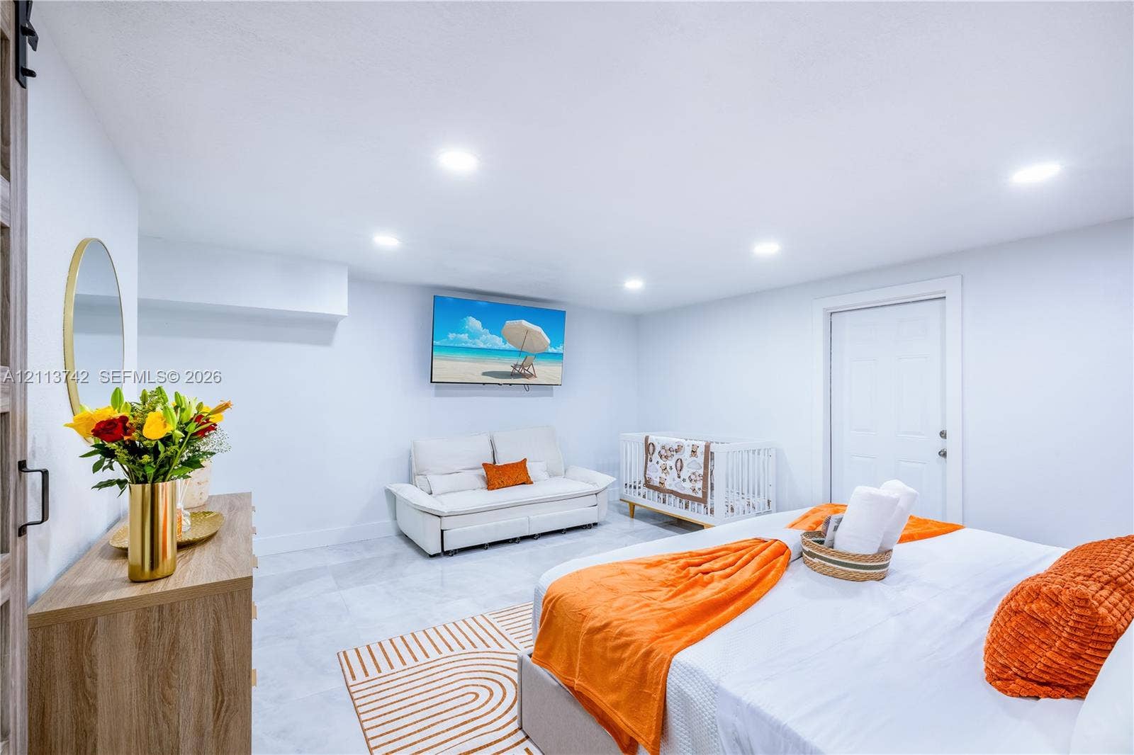 1930 NW 163rd St Road, Miami Gardens, FL 33054 Neutral-toned room featuring recessed lighting, smooth-finish walls, polished tile flooring, and a wall-mounted sliding door