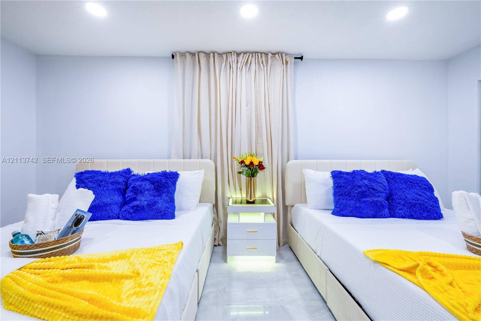 1930 NW 163rd St Road, Miami Gardens, FL 33054 Recessed ceiling lighting, glossy light-toned flooring, and a central built-in nightstand with integrated under-shelf illumination