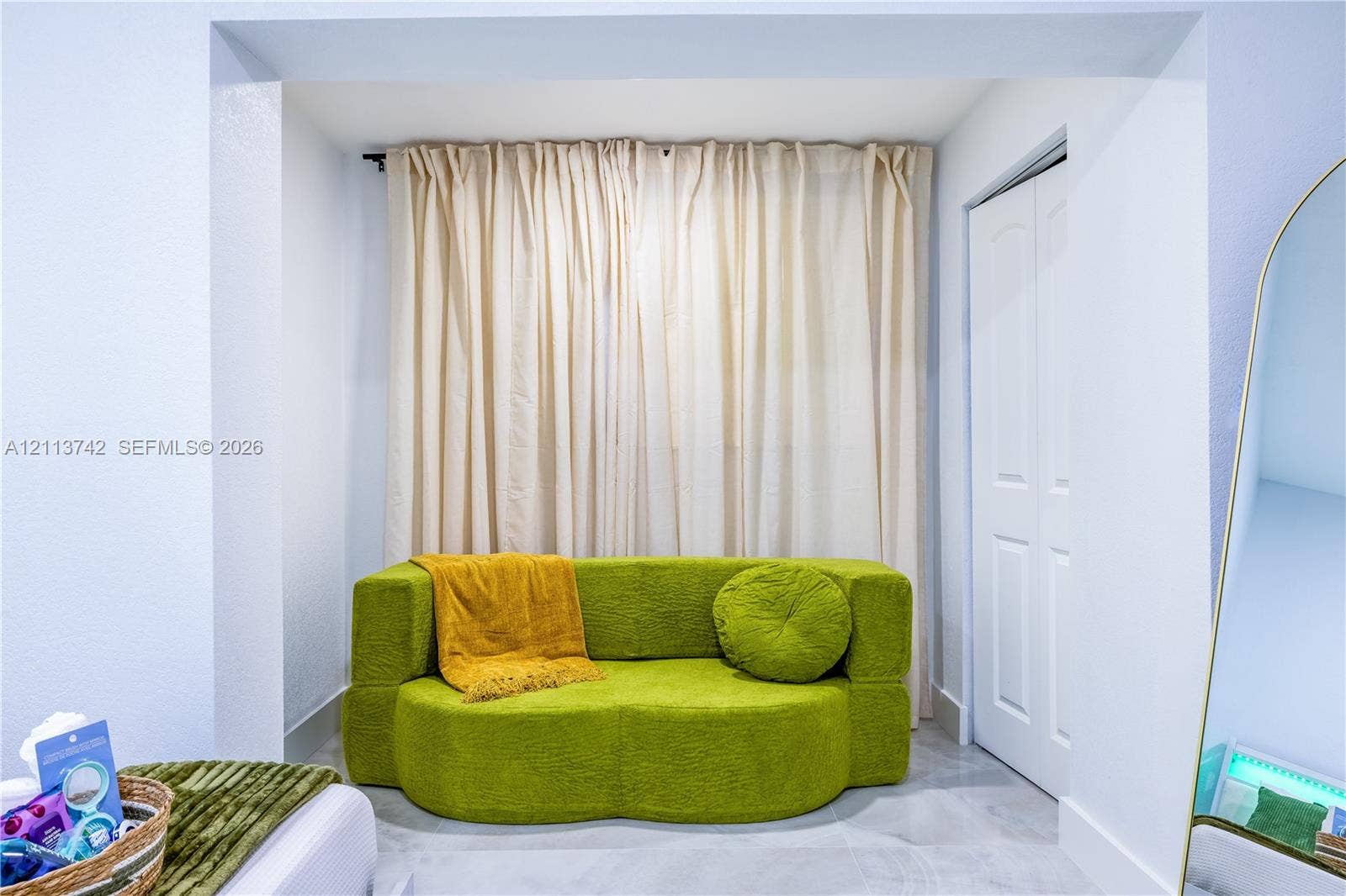 1930 NW 163rd St Road, Miami Gardens, FL 33054 Recessed nook featuring light-toned tile flooring and a bi-fold closet door