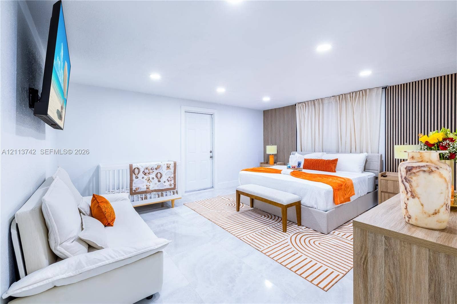 1930 NW 163rd St Road, Miami Gardens, FL 33054 Sleek room featuring polished tile flooring, recessed ceiling lighting, and a decorative wood-slat accent wall
