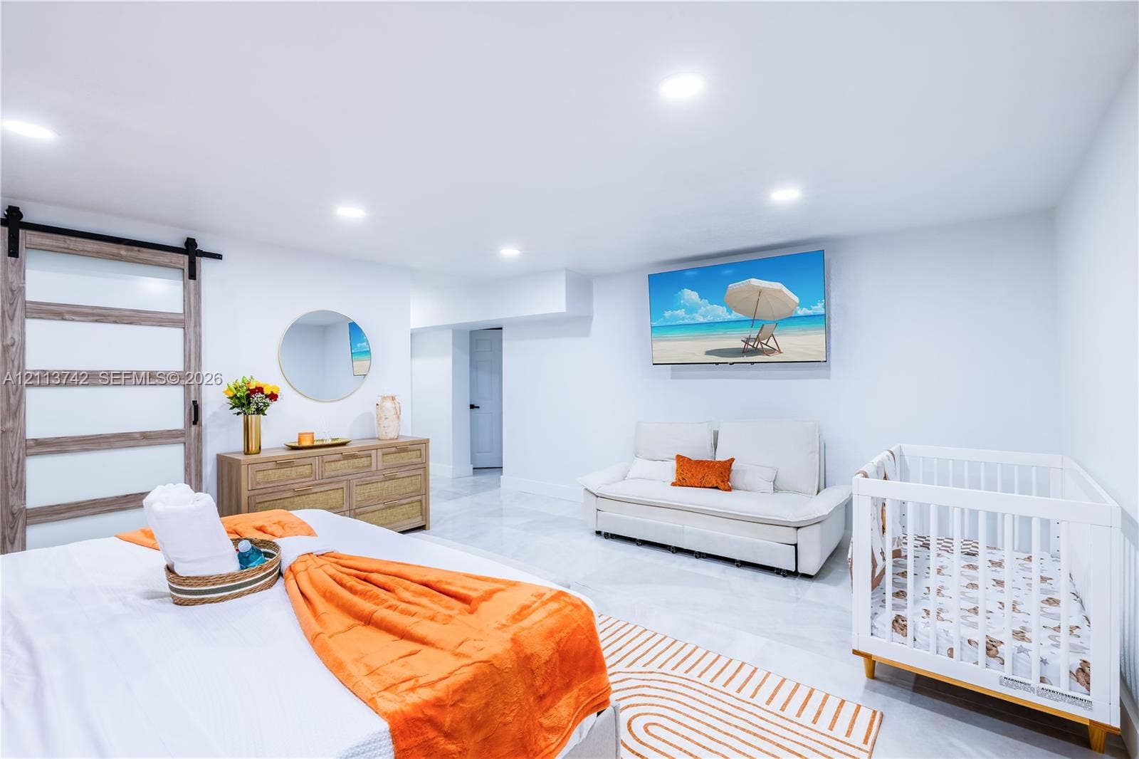 1930 NW 163rd St Road, Miami Gardens, FL 33054 Interior space featuring a sliding barn door with glass panels, large-format tile flooring, and recessed ceiling lighting