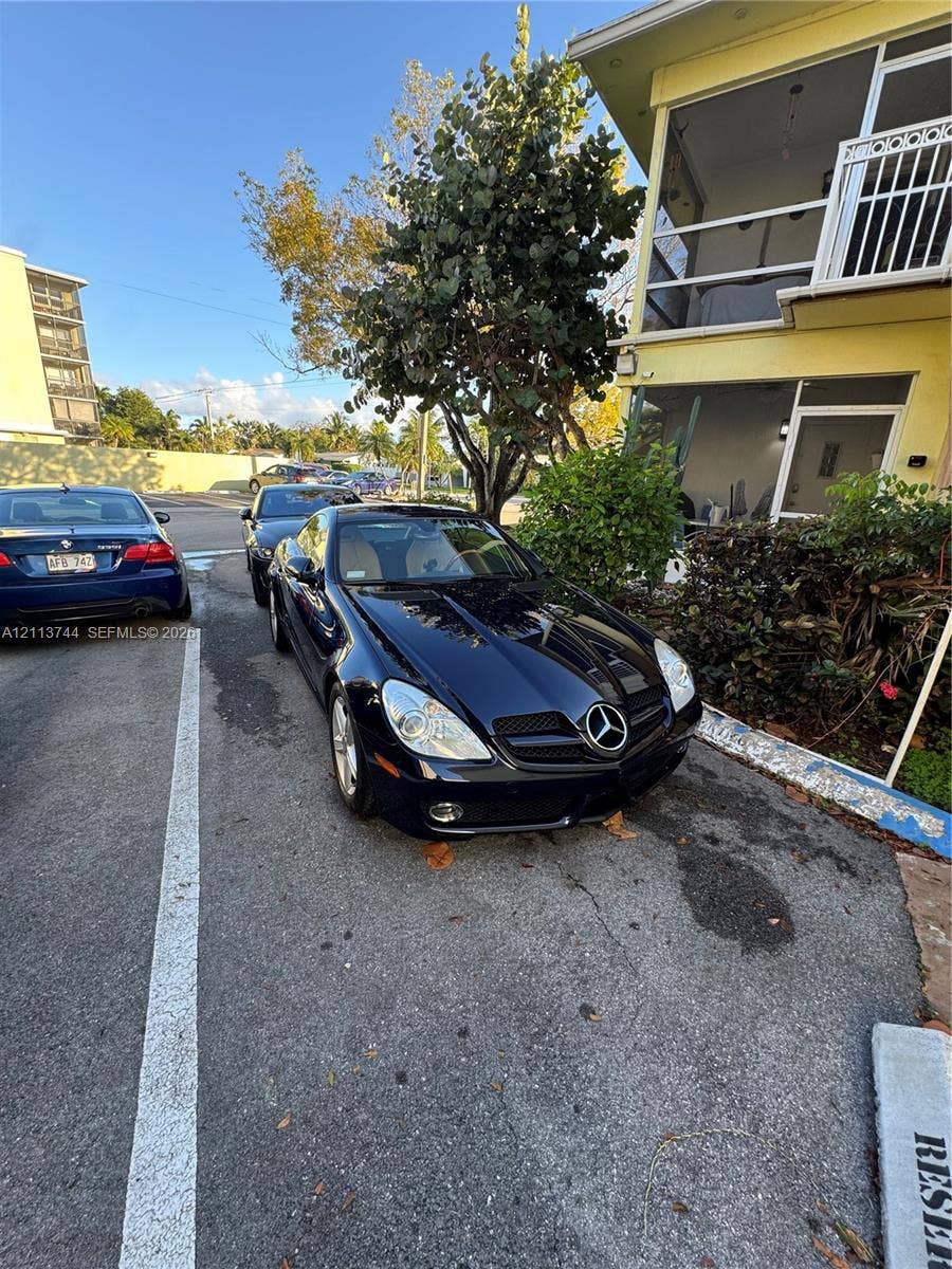 1501 Arthur Street, #1, Hollywood, FL 33020 Exterior featuring a multi-story building with screened-in porches and paved off-street parking
