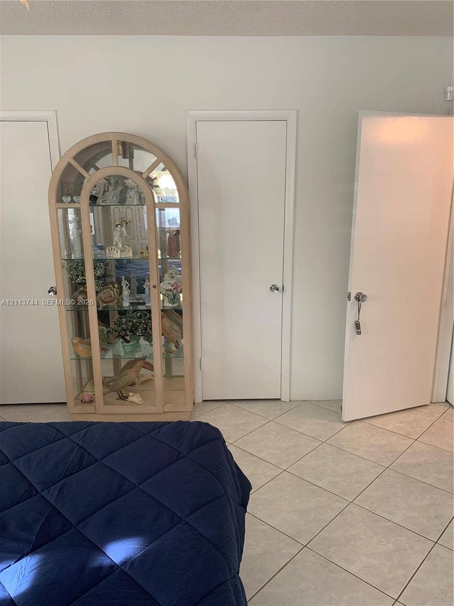 1501 Arthur Street, #1, Hollywood, FL 33020 Neutral-toned ceramic tile flooring and white interior doors with brushed metal hardware