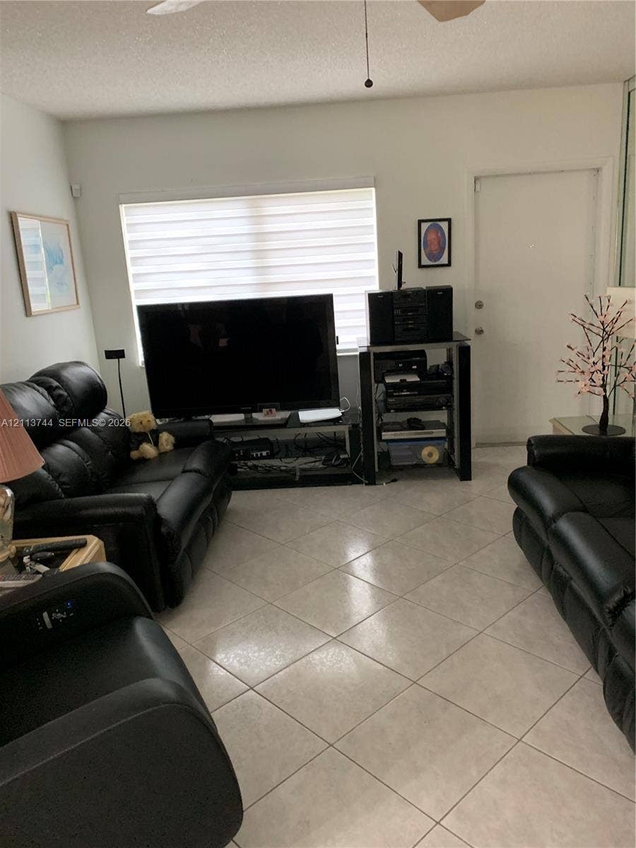 1501 Arthur Street, #1, Hollywood, FL 33020 Ceramic tile flooring arranged in a diagonal pattern, horizontal window blinds, and a ceiling fan