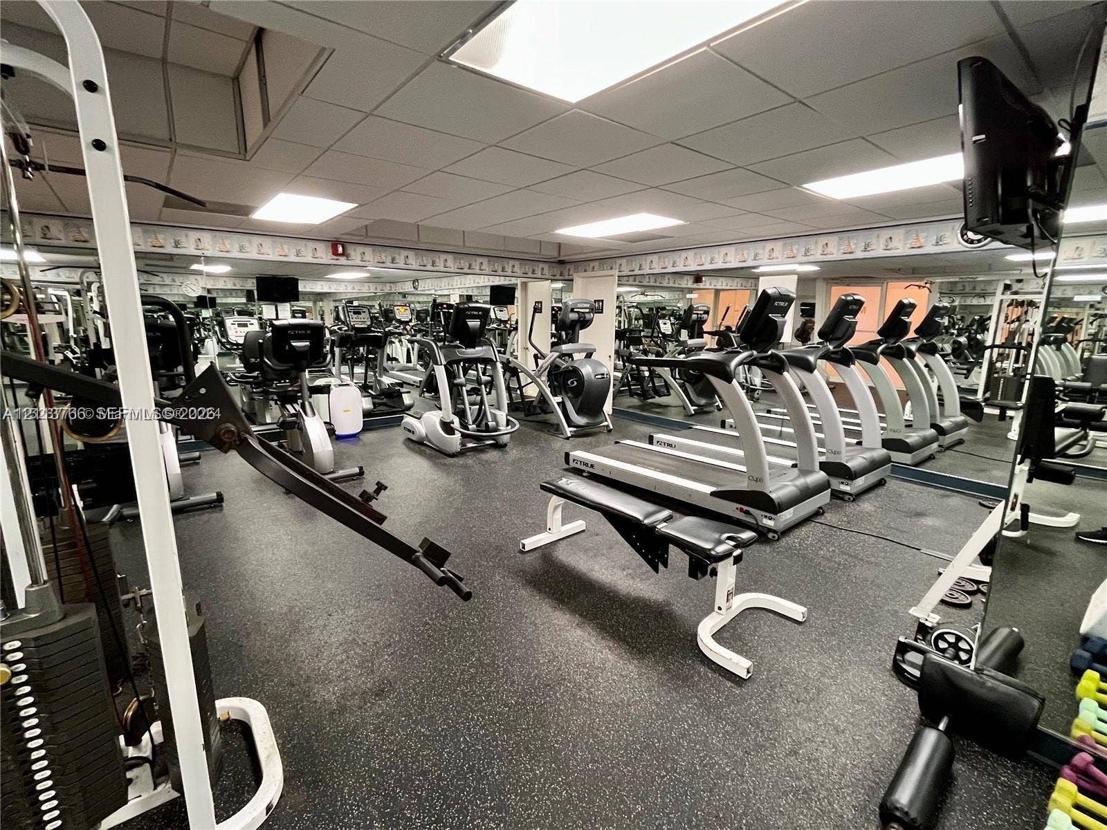 2899 Collins Avenue, #1429, Miami Beach, Miami Beach, FL 33140 Fitness center featuring wall-to-wall mirrors, recessed drop-ceiling lighting, and specialized rubberized flooring