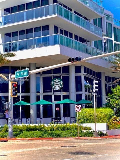 2899 Collins Avenue, #1429, Miami Beach, Miami Beach, FL 33140 Multi-story building exterior featuring floor-to-ceiling glass windows and expansive cantilevered balconies with glass railings
