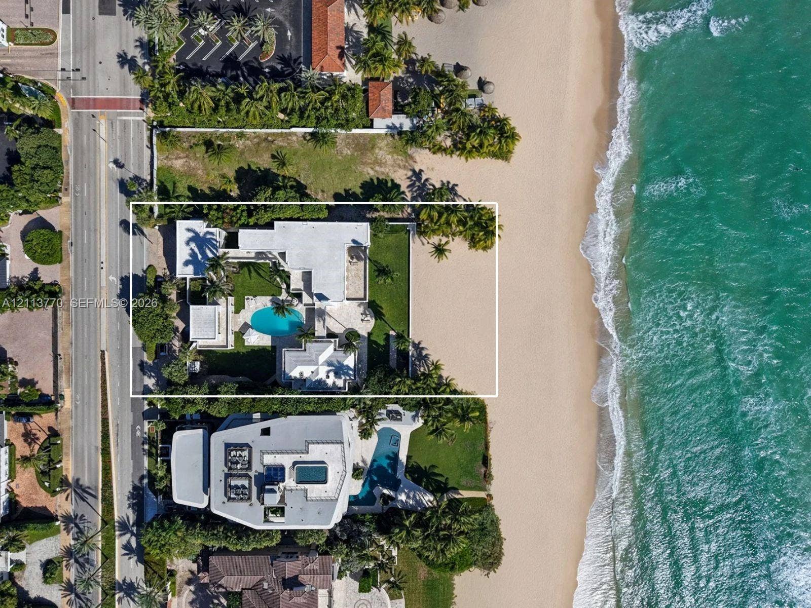 387 Ocean Boulevard, Golden Beach, Golden Beach, FL 33160 Direct oceanfront property featuring a private swimming pool, expansive paved patio, manicured lawn, and mature perimeter landscaping