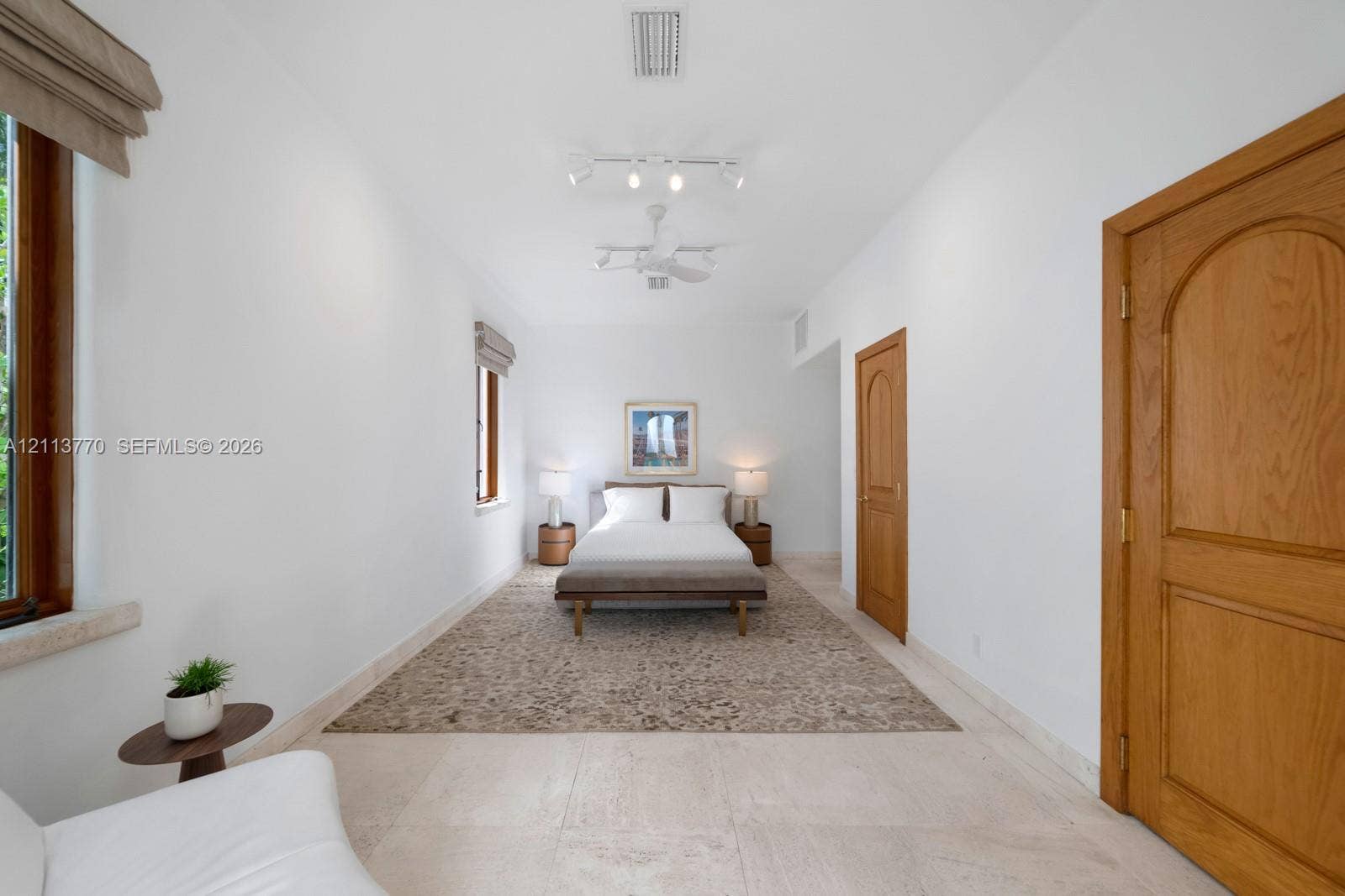 387 Ocean Boulevard, Golden Beach, Golden Beach, FL 33160 Neutral stone flooring, arched wood-finish doors, and adjustable track lighting