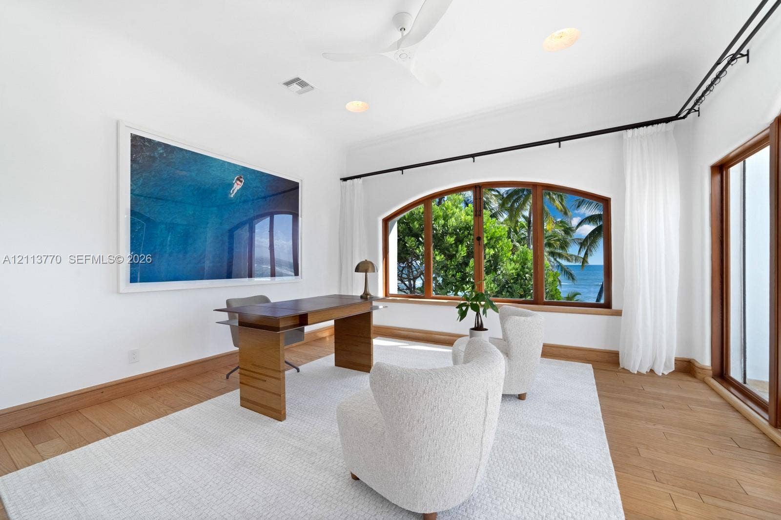387 Ocean Boulevard, Golden Beach, Golden Beach, FL 33160 Room featuring wood-finish flooring, an arched window with wood trim, ceiling fan, and recessed lighting