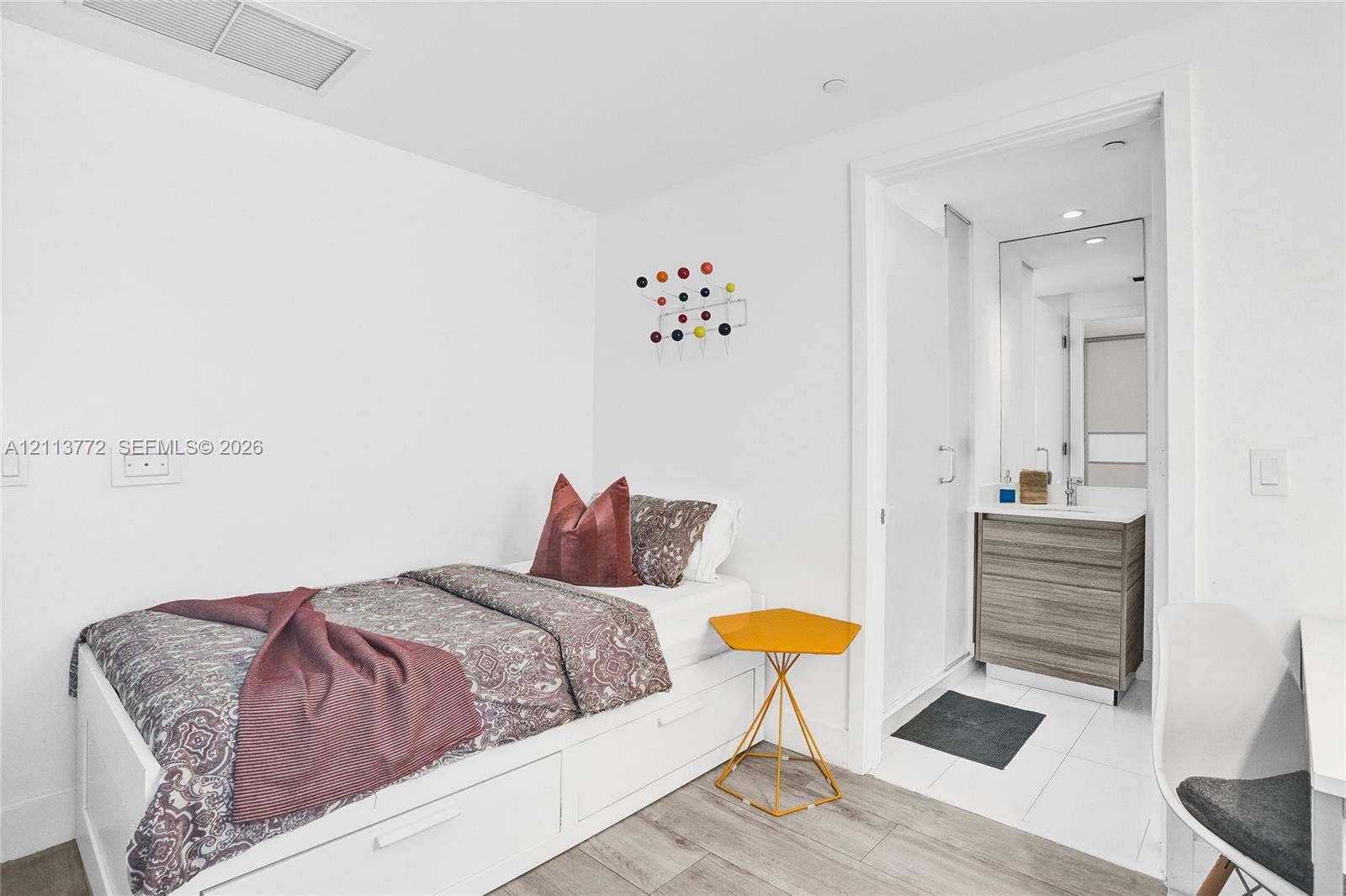 Wood-finish flooring, built-in storage cabinetry, and recessed lighting