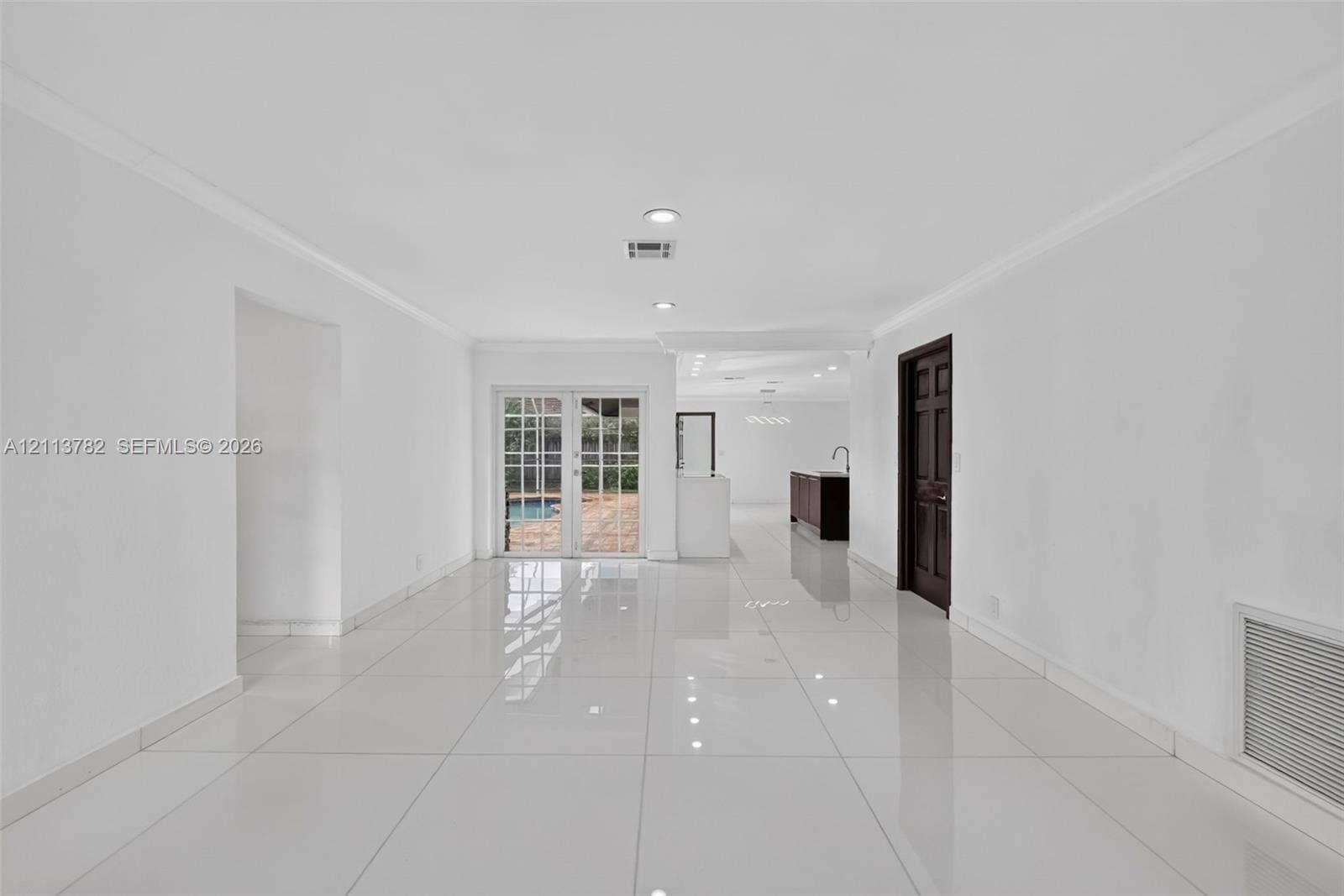 4720 Bayview Drive, Fort Lauderdale, FL 33308 Open-concept room featuring large-format tile flooring, recessed lighting, and white-framed glass French doors