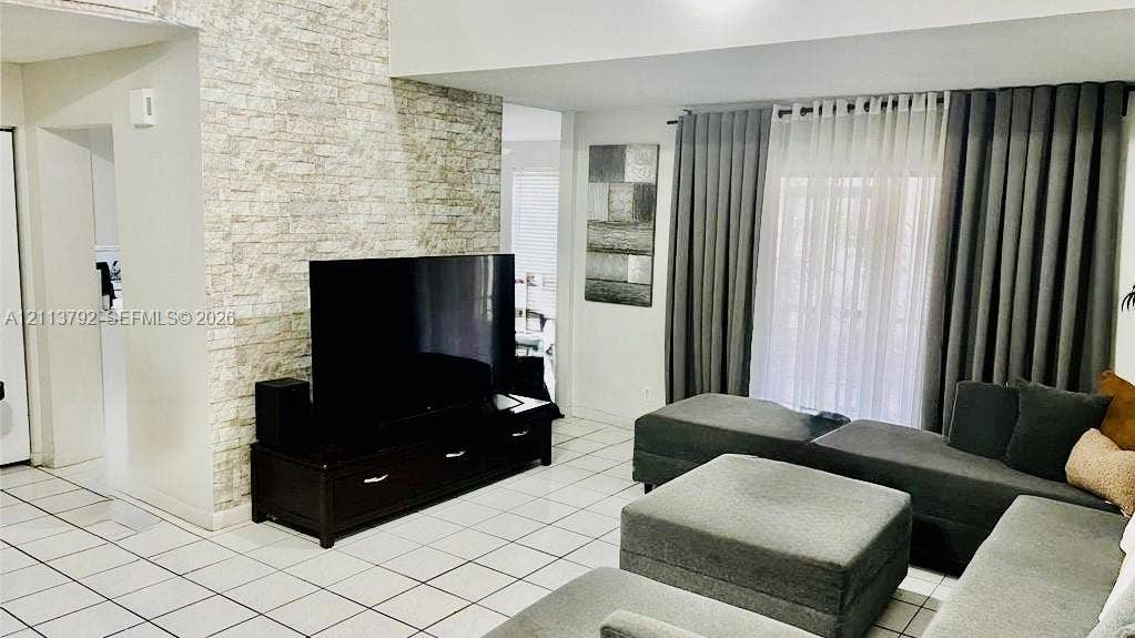 11530 NW 43rd, #1, Coral Springs, Coral Springs, FL 33065 Floor-to-ceiling ston/Users/vishpersaud/Pictures/back yard 3.webpe-veneer accent wall, ceramic tile flooring, and large window treatment