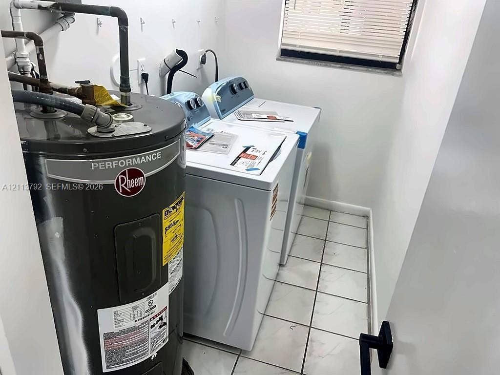 11530 NW 43rd, #1, Coral Springs, Coral Springs, FL 33065 Utility area featuring light-toned tile flooring, a Rheem performance water heater, and a window with horizontal blinds