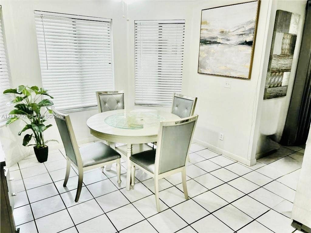 11530 NW 43rd, #1, Coral Springs, Coral Springs, FL 33065 Bright dining area featuring ceramic tile flooring, neutral walls, and multiple windows with installed horizontal blinds