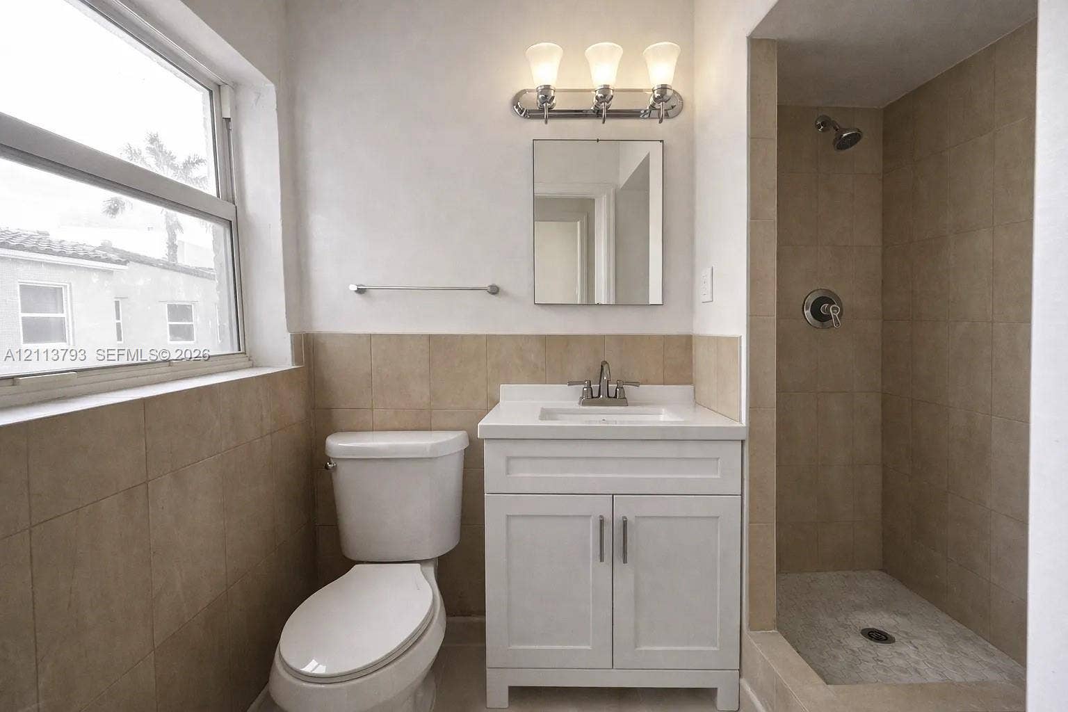 2638 Johnson Street, #53, Hollywood, Hollywood, FL 33020 Bathroom featuring a white vanity cabinet, square undermount sink, three-light polished chrome fixture, and walk-in tiled shower