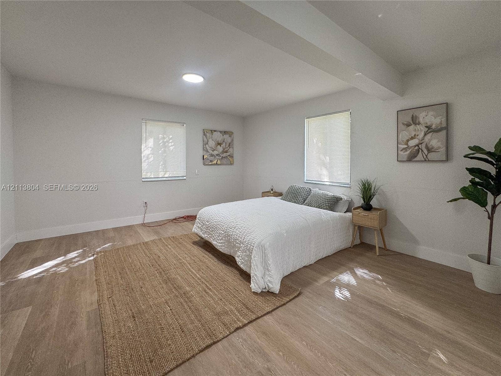 2300 NW 31st Avenue, Fort Lauderdale, FL 33311 Spacious interior featuring wood-finish flooring, neutral wall tones, two windows with horizontal blinds, and recessed ceiling lighting