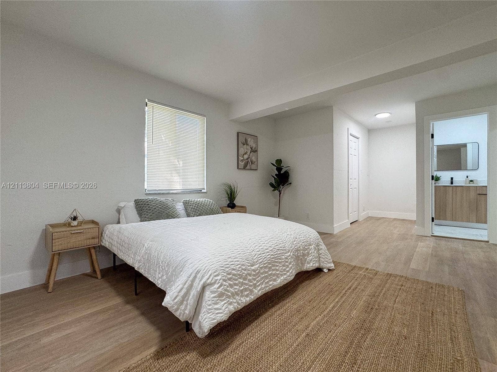 2300 NW 31st Avenue, Fort Lauderdale, FL 33311 Neutral interior featuring light-tone wood-finish flooring, recessed lighting, and a window with integrated blinds