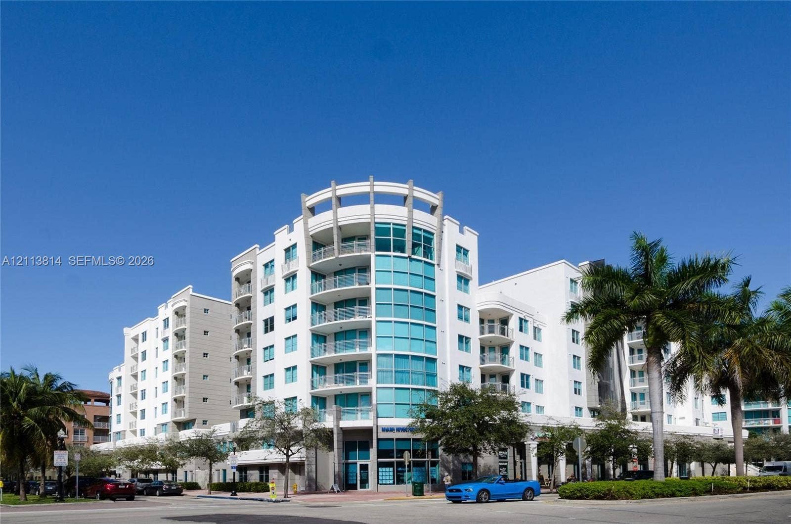 110 Washington Avenue, #1517, Miami Beach, Miami Beach, FL 33139 Multi-story building exterior featuring a curved facade, expansive glass windows, and private balconies