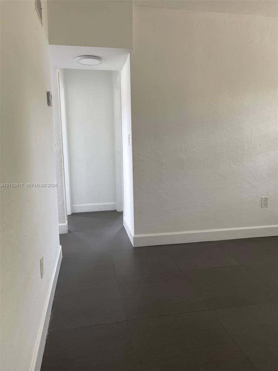2515 NW 52nd Street, #1, Miami, Miami, FL 33142 Neutral-toned walls paired with large-format tile flooring and recessed overhead lighting