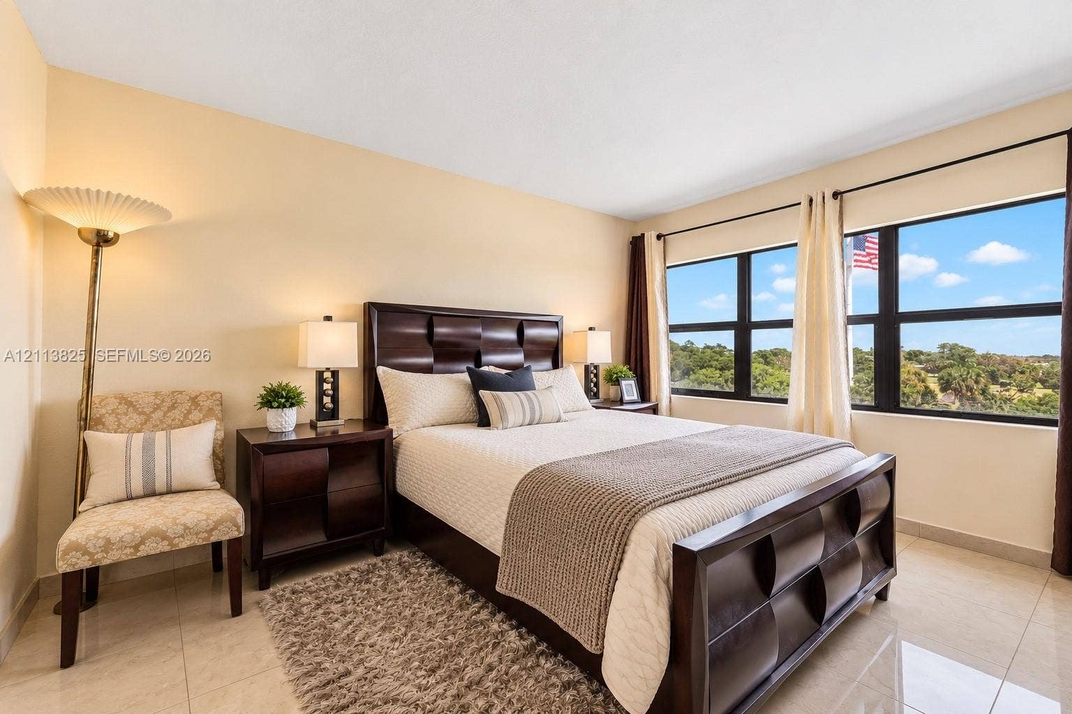 1200 NW 80th Avenue, #405A, Margate, FL 33063 Bedroom featuring tile flooring, neutral wall tones, and large horizontal windows with exterior landscape exposure
