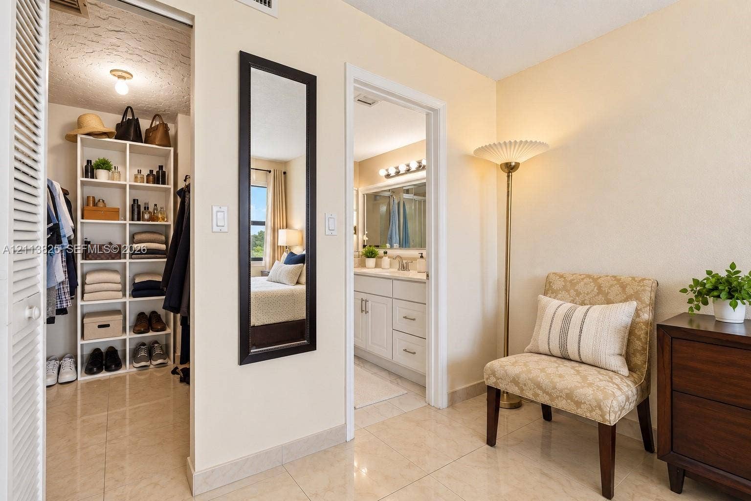 1200 NW 80th Avenue, #405A, Margate, FL 33063 Walk-in closet featuring built-in white shelving, polished tile flooring, and a louvered door