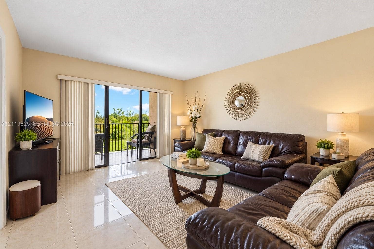 1200 NW 80th Avenue, #405A, Margate, FL 33063 Living area featuring polished tile flooring and sliding glass doors with access to an exterior balcony