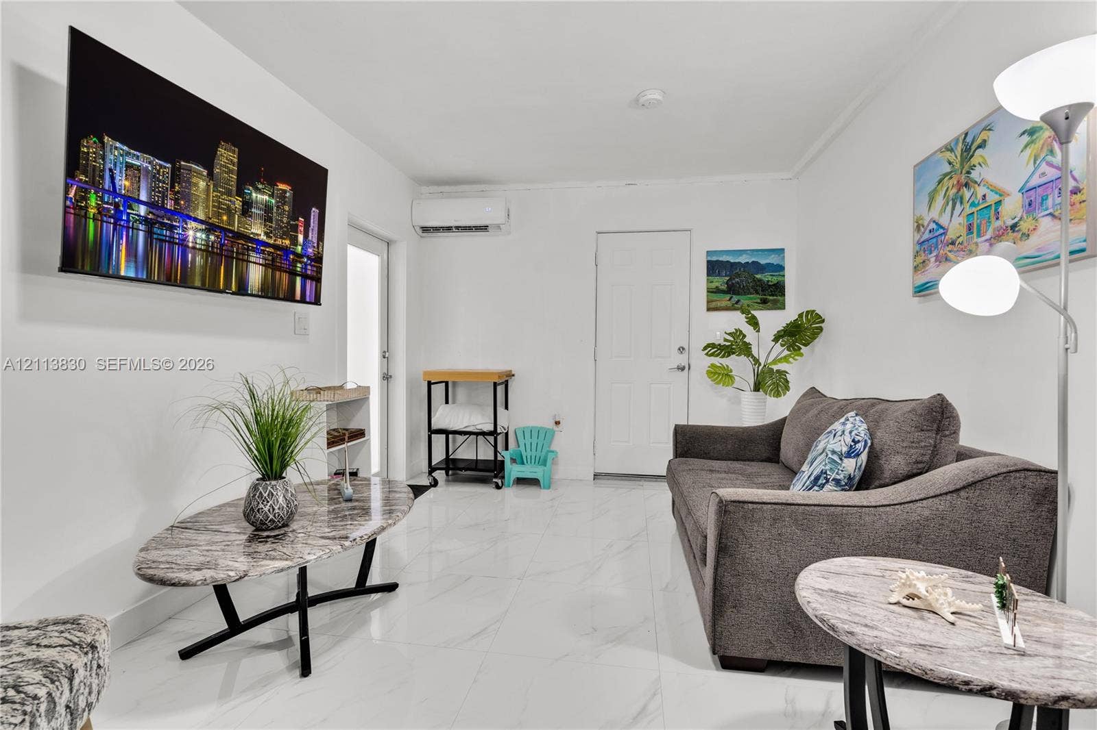 3545 SW 104th Court, Miami, FL 33165 Interior space featuring white stone-finish flooring and a wall-mounted ductless mini-split HVAC unit