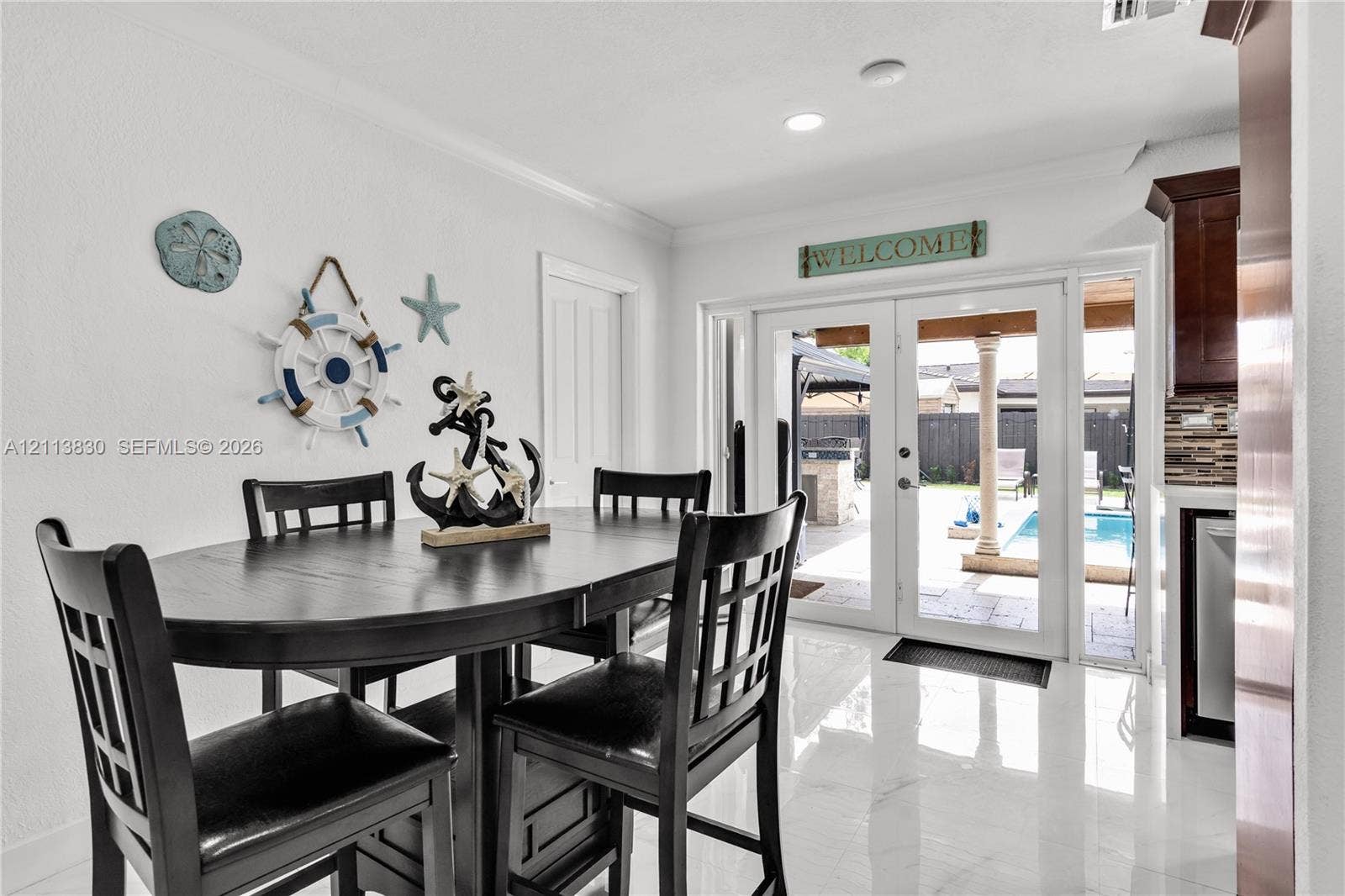 3545 SW 104th Court, Miami, FL 33165 Glossy tile flooring, double glass panel doors, and recessed lighting