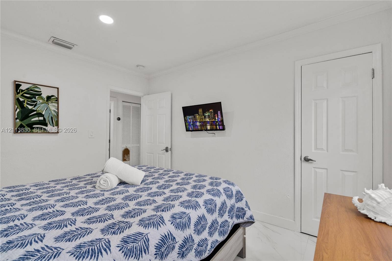 3545 SW 104th Court, Miami, FL 33165 Neutral-toned interior featuring recessed lighting, smooth-finish ceilings with crown molding, six-panel interior doors, and polished stone-finish tile flooring