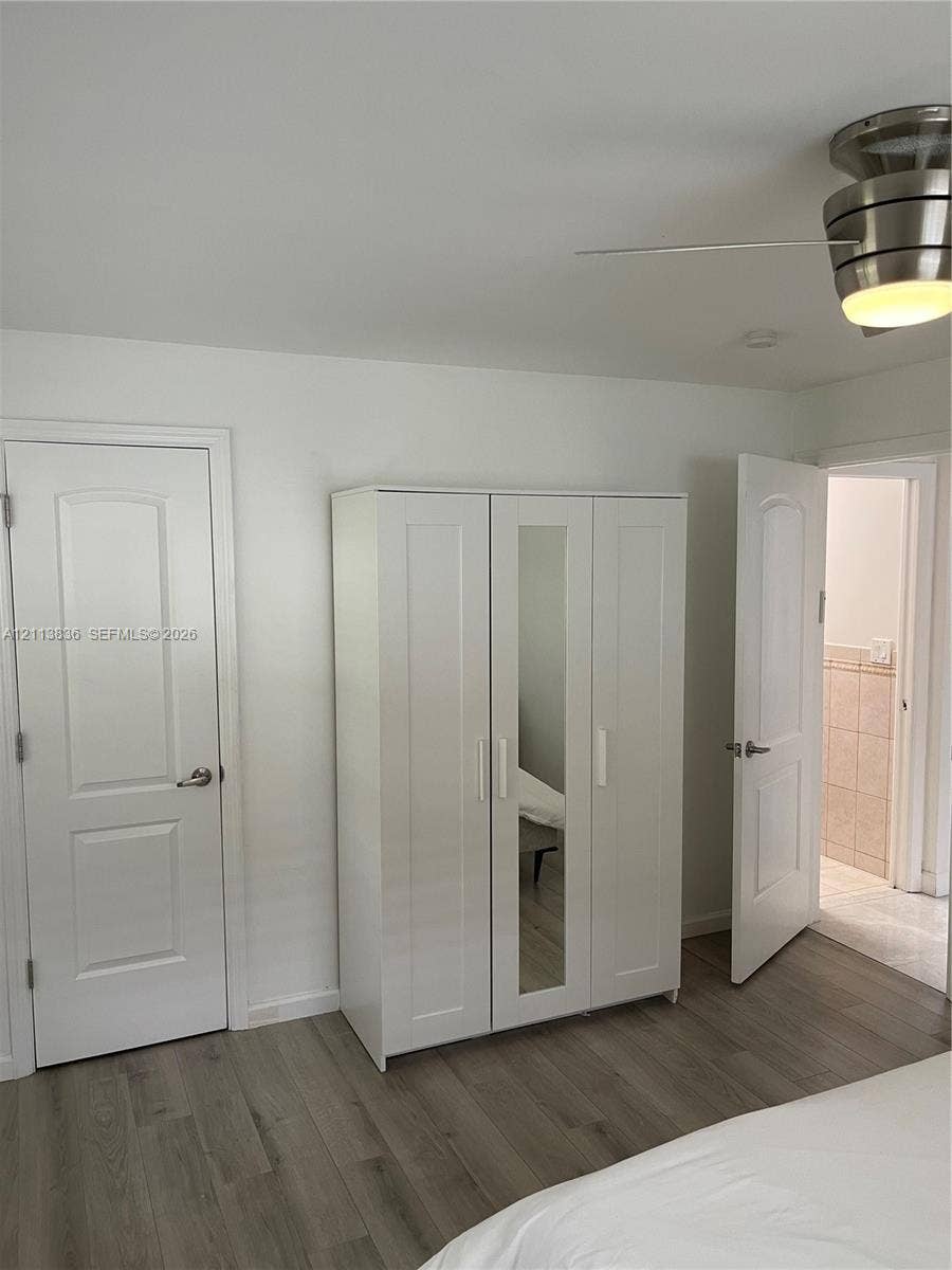 10153 SW 51st Street, Cooper City, Cooper City, FL 33328 Wood-finish flooring, brushed nickel ceiling fan with integrated lighting, and solid core interior doors with brushed nickel hardware