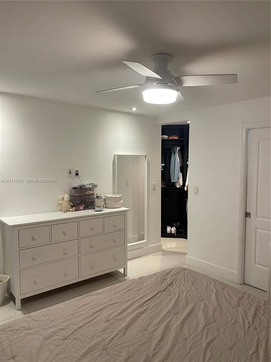 10153 SW 51st Street, Cooper City, Cooper City, FL 33328 Flush-mount ceiling fan with integrated lighting, polished tile flooring, recessed ceiling light, and built-in closet cabinetry