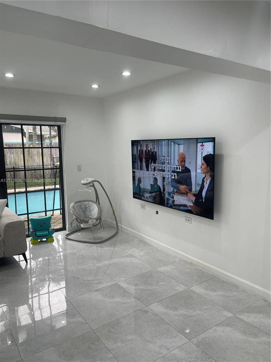 10153 SW 51st Street, Cooper City, Cooper City, FL 33328 Glossy tile flooring, recessed ceiling lighting, and a black-framed sliding glass door providing external exposure