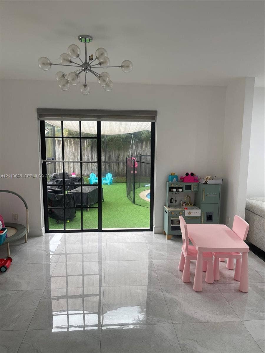 10153 SW 51st Street, Cooper City, Cooper City, FL 33328 Large-format neutral tile flooring paired with a contemporary multi-arm sputnik chandelier
