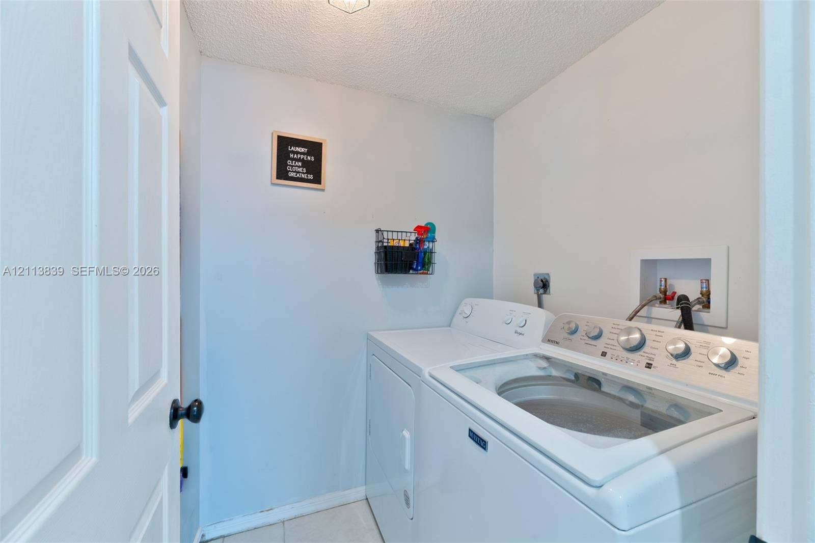 1015 NW 124th Terrace, Sunrise, FL 33323 Laundry area featuring washer and dryer hookups with dedicated water supply lines and recessed wall box