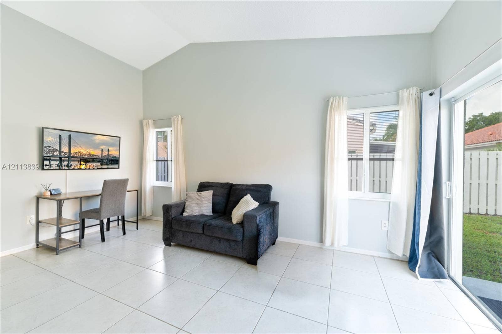 1015 NW 124th Terrace, Sunrise, FL 33323 Vaulted ceilings, large-format tile flooring, and sliding glass patio doors