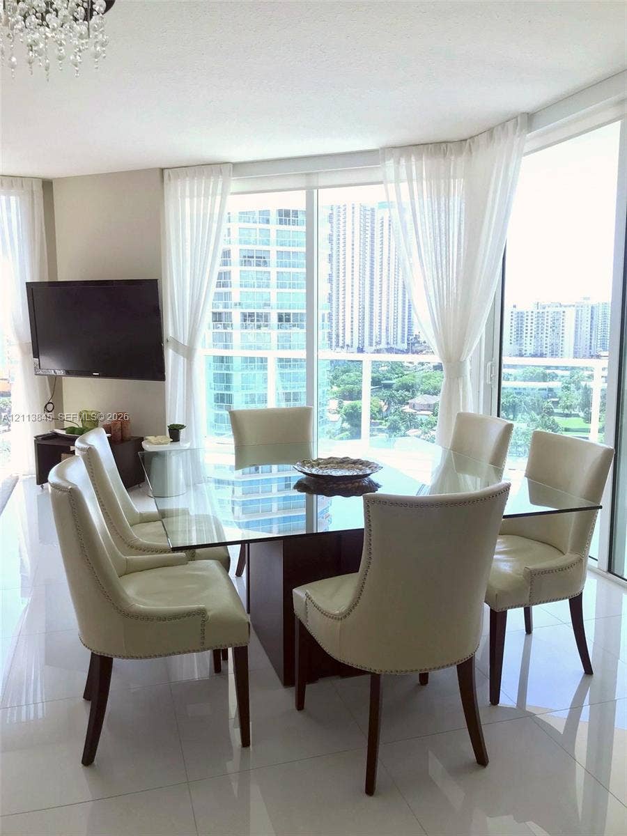 250 Sunny Isles Boulevard, #3-1506, Sunny Isles Beach, Sunny Isles Beach, FL 33160 Floor-to-ceiling glass paneling, polished tile flooring, crystal chandelier, and wrap-around window configuration