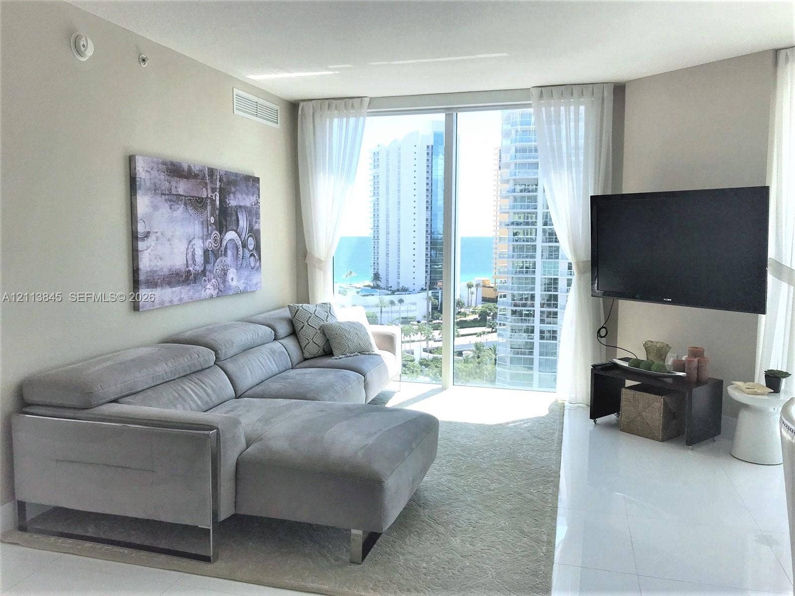250 Sunny Isles Boulevard, #3-1506, Sunny Isles Beach, Sunny Isles Beach, FL 33160 Floor-to-ceiling windows, polished white flooring, and neutral wall tones