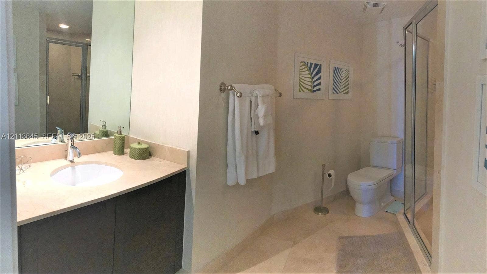 250 Sunny Isles Boulevard, #3-1506, Sunny Isles Beach, Sunny Isles Beach, FL 33160 Bathroom featuring a vanity with a stone countertop, an integrated sink with a chrome faucet, full-width mirror, tile flooring, and a glass-enclosed shower