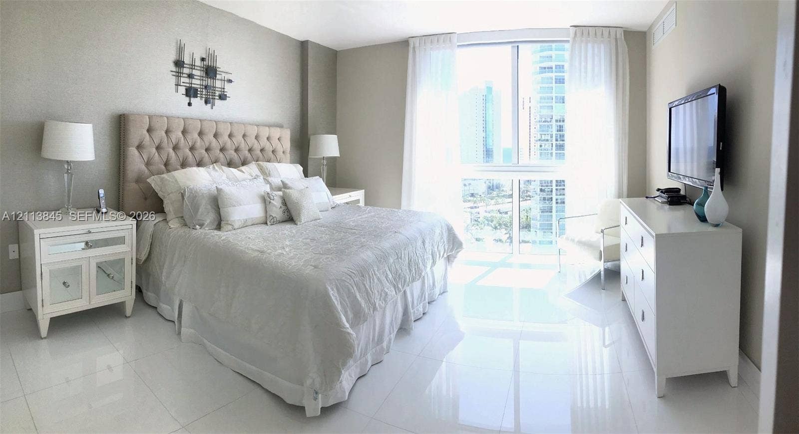 250 Sunny Isles Boulevard, #3-1506, Sunny Isles Beach, Sunny Isles Beach, FL 33160 Floor-to-ceiling windows featuring urban scenery, complemented by polished light-toned tile flooring throughout