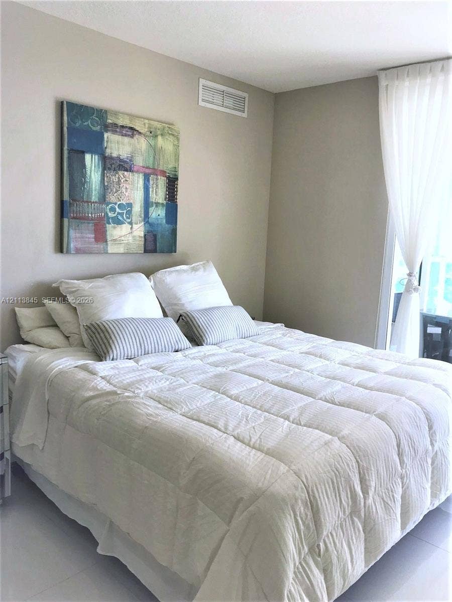 250 Sunny Isles Boulevard, #3-1506, Sunny Isles Beach, Sunny Isles Beach, FL 33160 Neutral-toned interior featuring high-gloss tile flooring and natural light through floor-to-ceiling window treatments