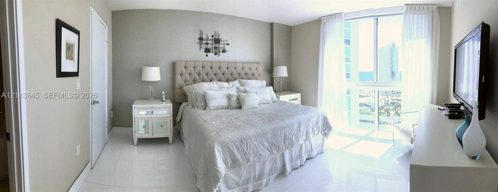 250 Sunny Isles Boulevard, #3-1506, Sunny Isles Beach, Sunny Isles Beach, FL 33160 Floor-to-ceiling windows with neutral drapery, large-format tile flooring, and smooth-finish walls