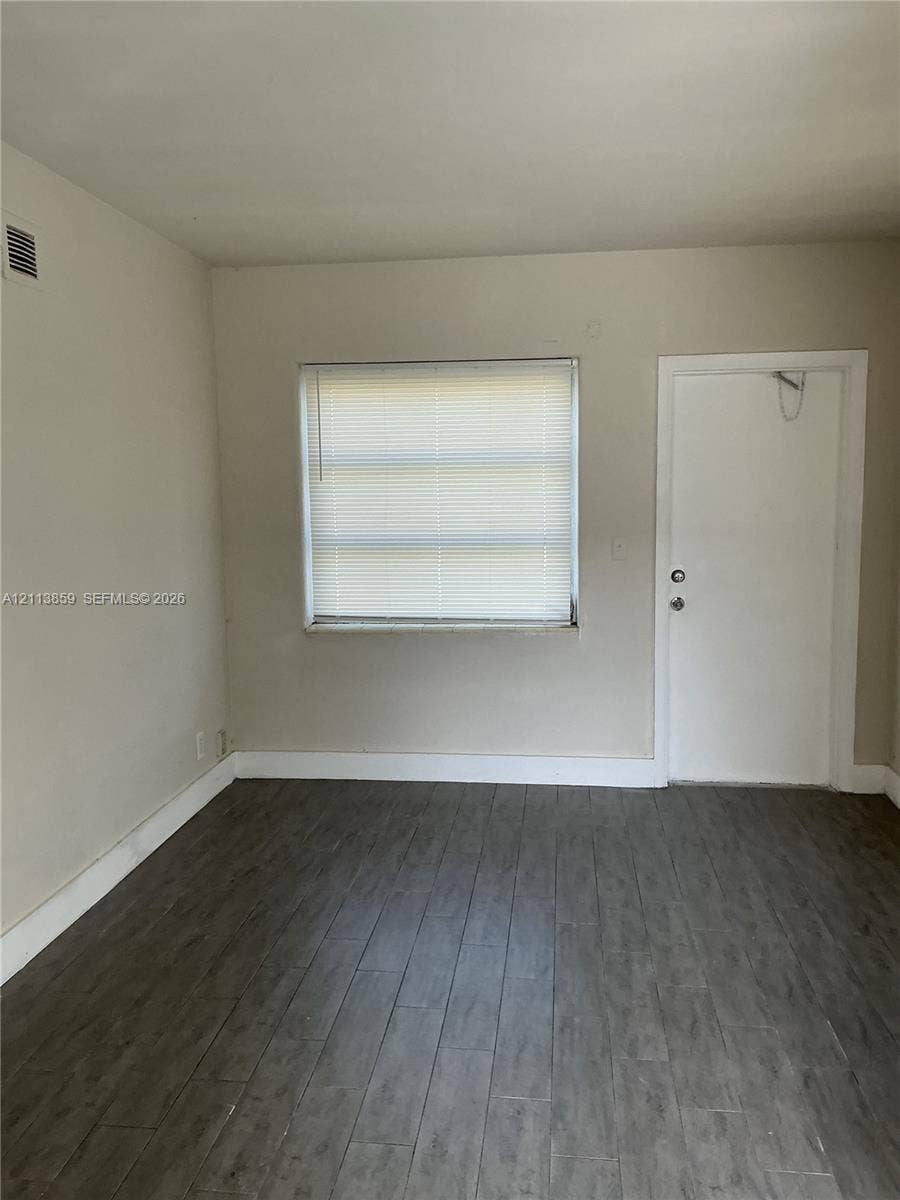 2222 Van Buren Street, #26, Hollywood, Hollywood, FL 33020 Wood-finish flooring, neutral wall tones, and single-pane window with horizontal blinds