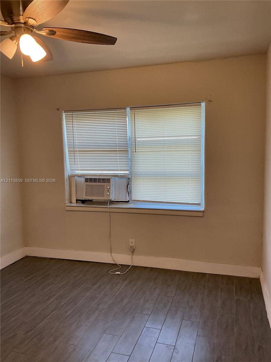 2222 Van Buren Street, #26, Hollywood, Hollywood, FL 33020 Wood-finish flooring, multi-pane window with installed blinds, and ceiling fan with integrated lighting