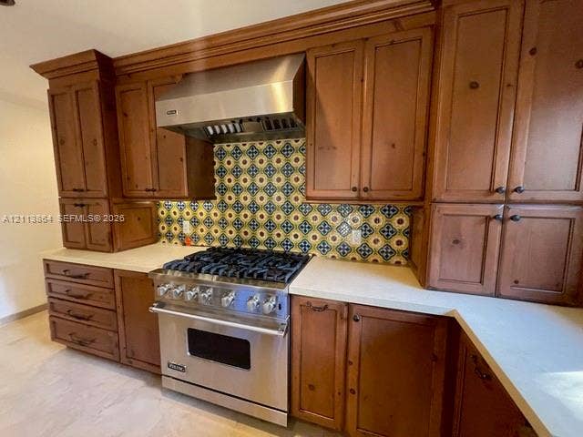 721 Tibidabo Avenue, #0, Coral Gables, Coral Gables, FL 33143 Kitchen featuring custom wood cabinetry, stainless steel professional-grade range, stainless steel vent hood, patterned tile backsplash, and light-toned countertops