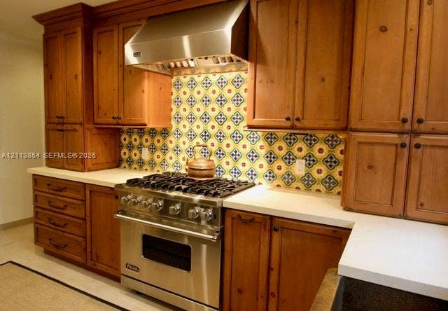 721 Tibidabo Avenue, #0, Coral Gables, Coral Gables, FL 33143 Custom stained-wood cabinetry, stainless steel professional-grade range, stainless steel range hood, patterned tile backsplash, and solid-surface countertops