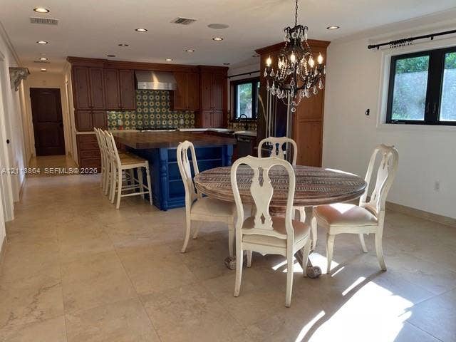 721 Tibidabo Avenue, #0, Coral Gables, Coral Gables, FL 33143 Kitchen featuring wood cabinetry, blue-painted center island with butcher-block countertop, recessed lighting, tile flooring, and a decorative chandelier